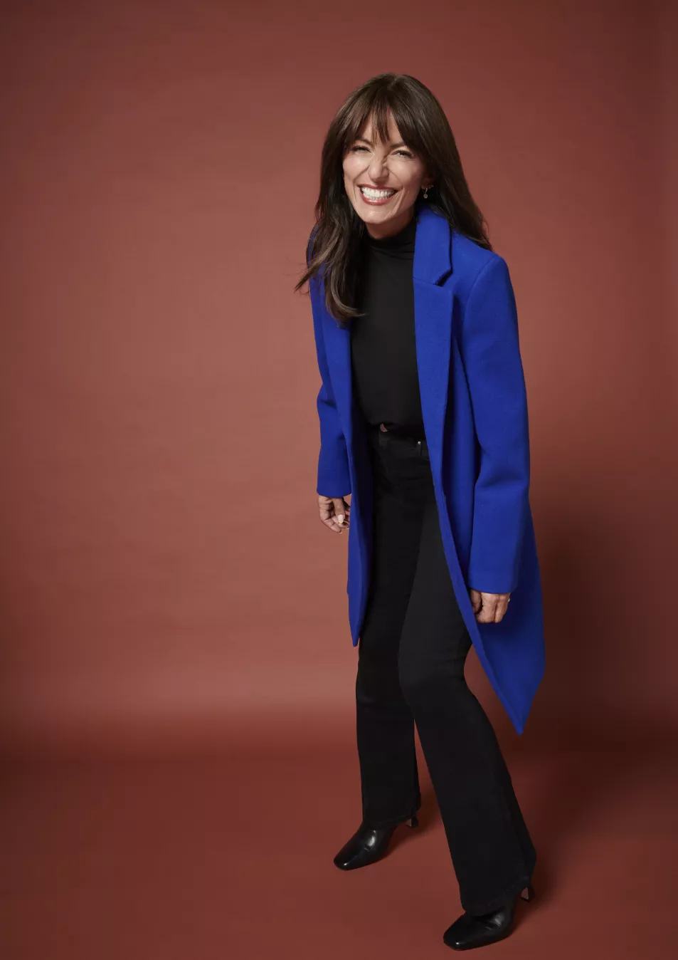 Davina McCall wearing Sosandar Coat, £125; Black High Neck Embellished Long Sleeve Top, £24; Square Toe Leather Boot, £70, available from JD Williams