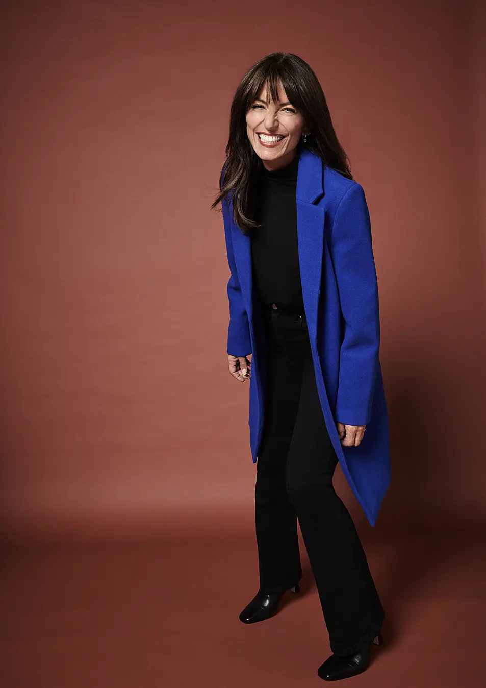 Davina McCall wearing Sosandar Coat, £125; Black High Neck Embellished Long Sleeve Top, £24; Square Toe Leather Boot, £70, available from JD Williams