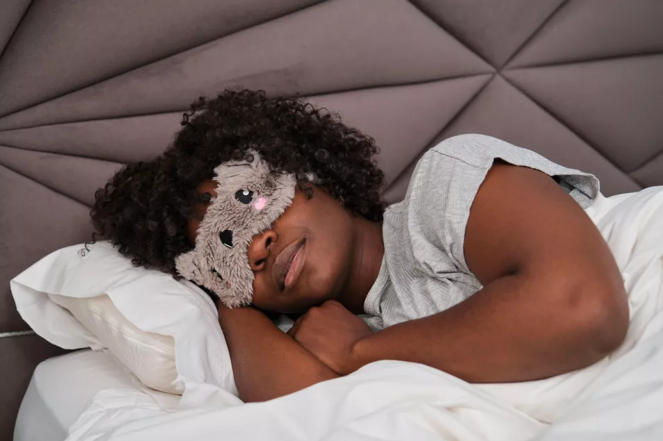 woman asleep in bed with eyemask