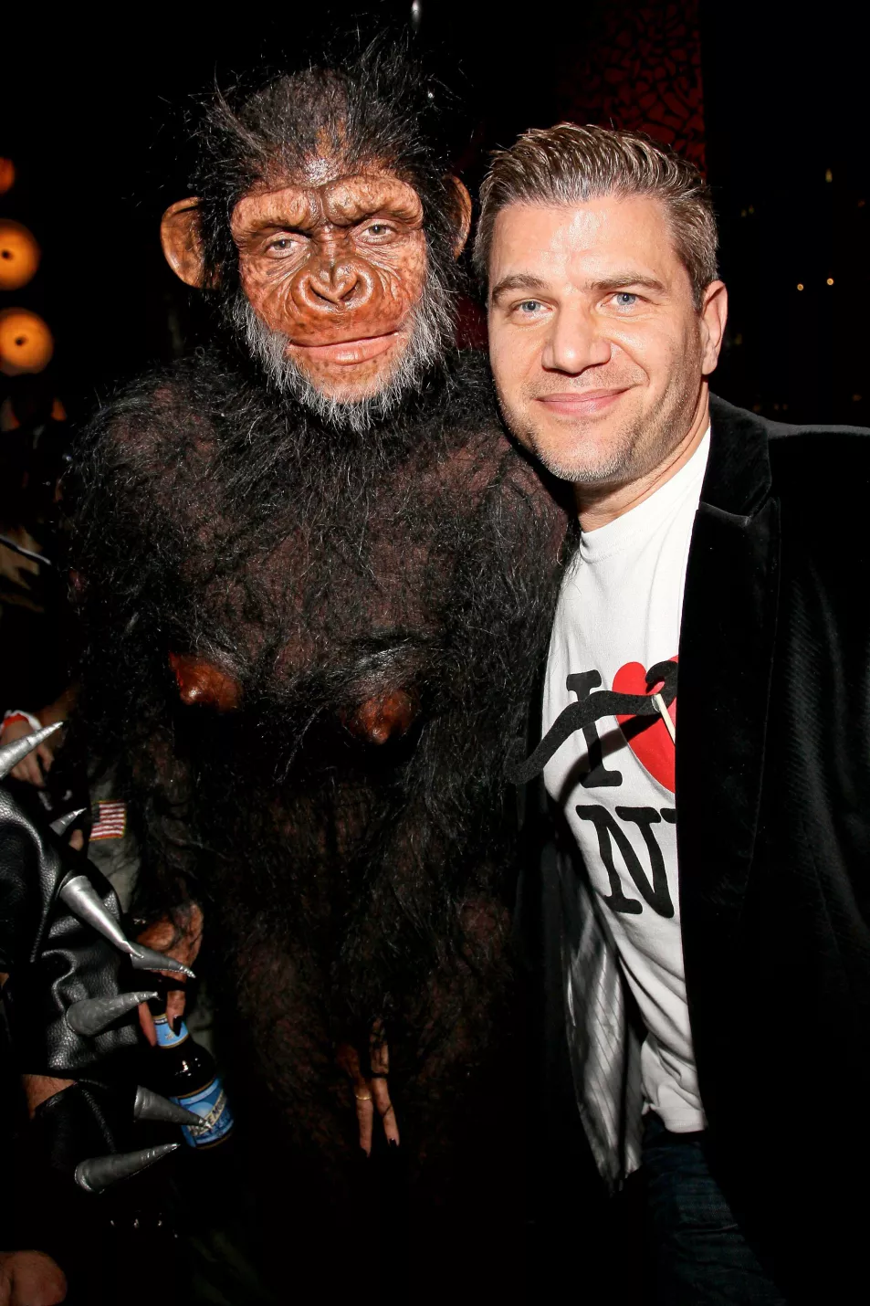 Heidi Klum poses with a fan while dresses as an ape for Halloween 2013