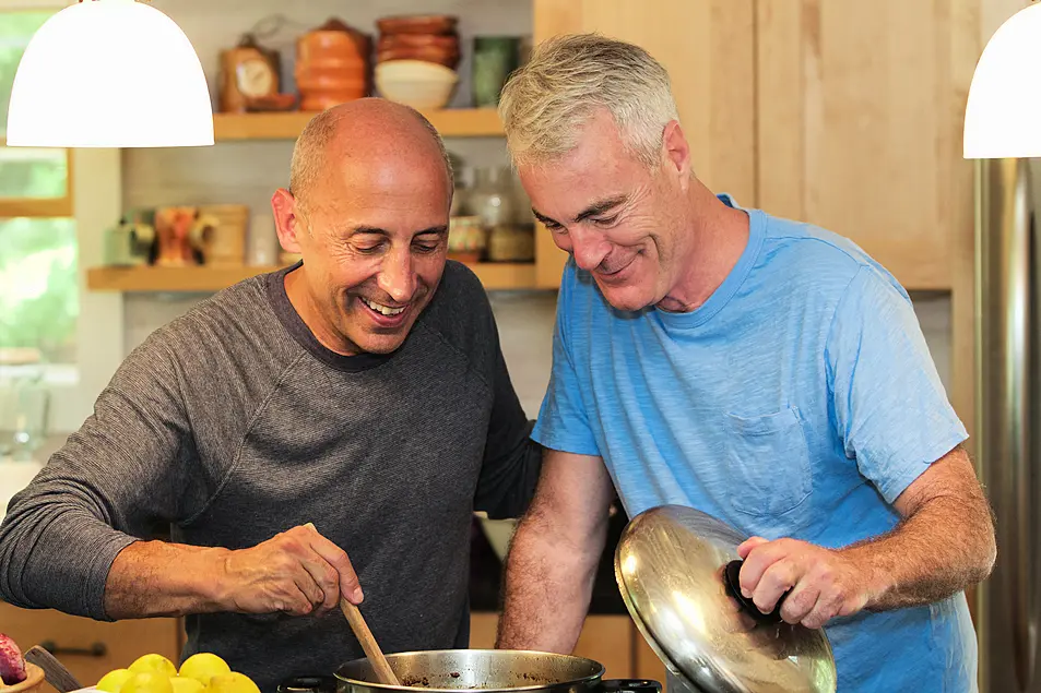 Mature gay couple cooking together