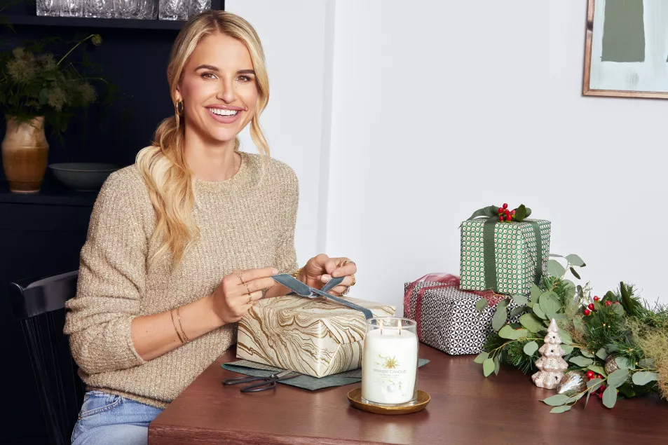 Vogue Williams sat at a table wrapping presents