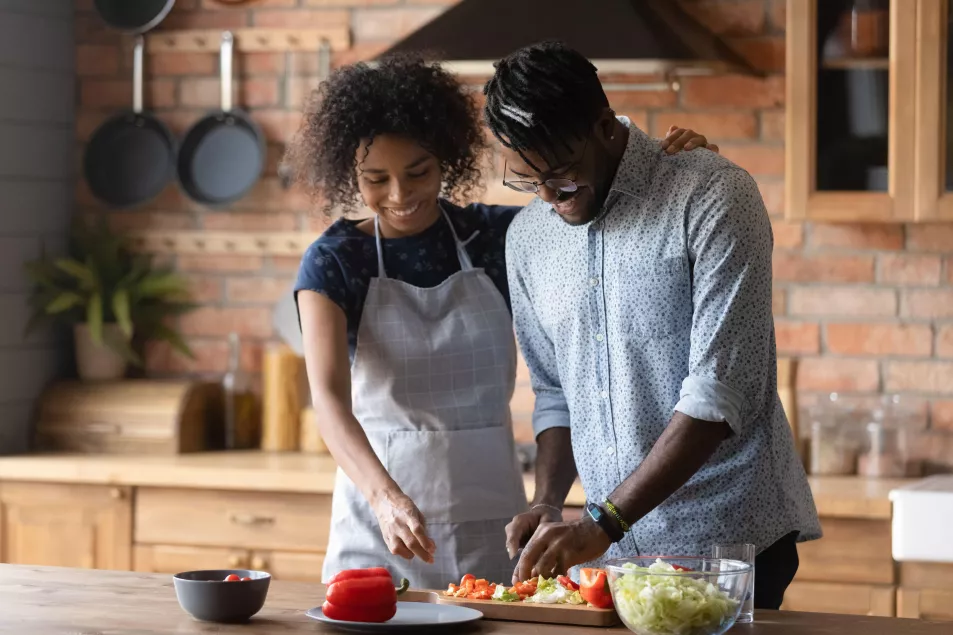 A black couple cooking healthy food together at home