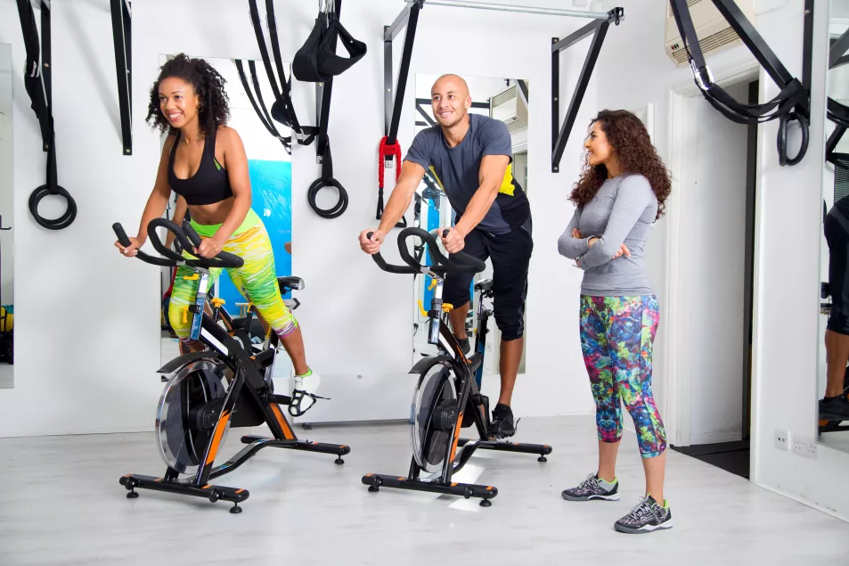 Group exercising on bikes in fitness studio
