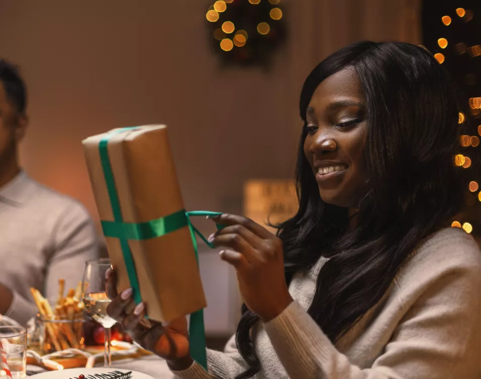 Woman opening Christmas present