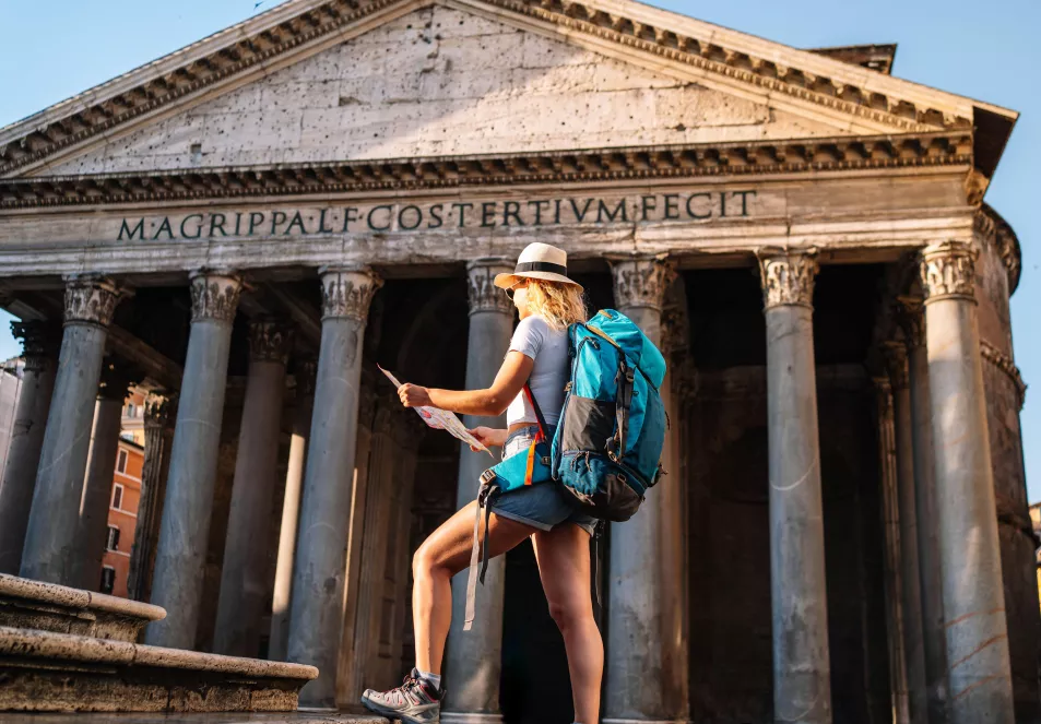 A woman with a map in front of the Pantheon in Rome