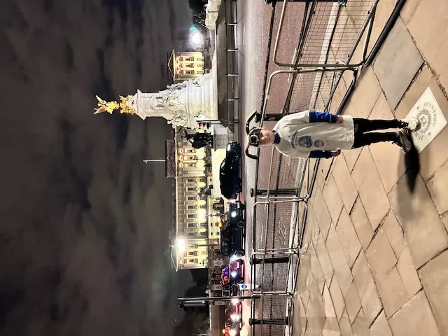 Barney Thomas standing in front of Buckingham Palace during the fundraising challenge 