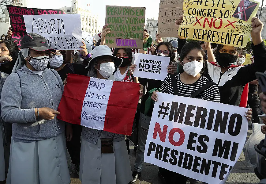 Woman holds protest sign