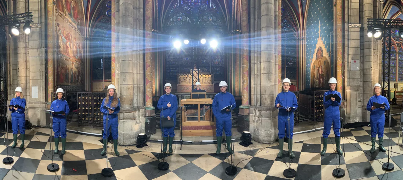 The choir wore hard hats and protective suits