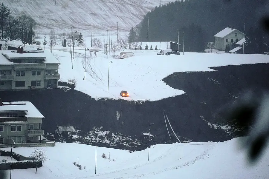 A car stops at the edge of a cliff after a landslide occurred in a residential area in Ask, near Oslo 