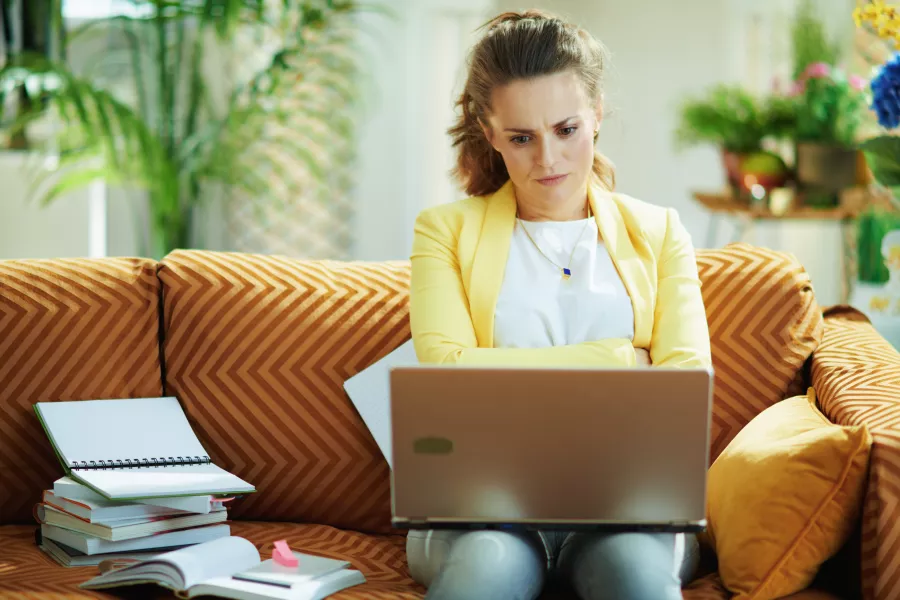 Unhappy woman looking at laptop