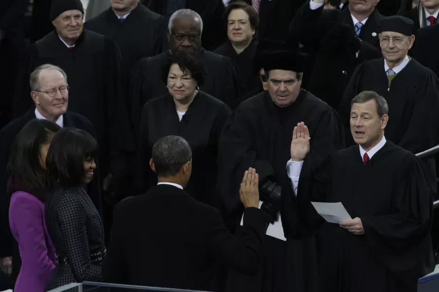 Chief Justice John Roberts, right, reads the oath of office to President Barack Obama