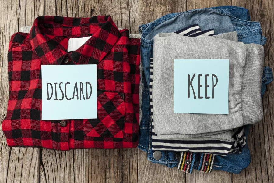 One pile of clothes 'to keep' one to 'discard' 