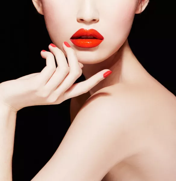 woman with red lipstick and red nails