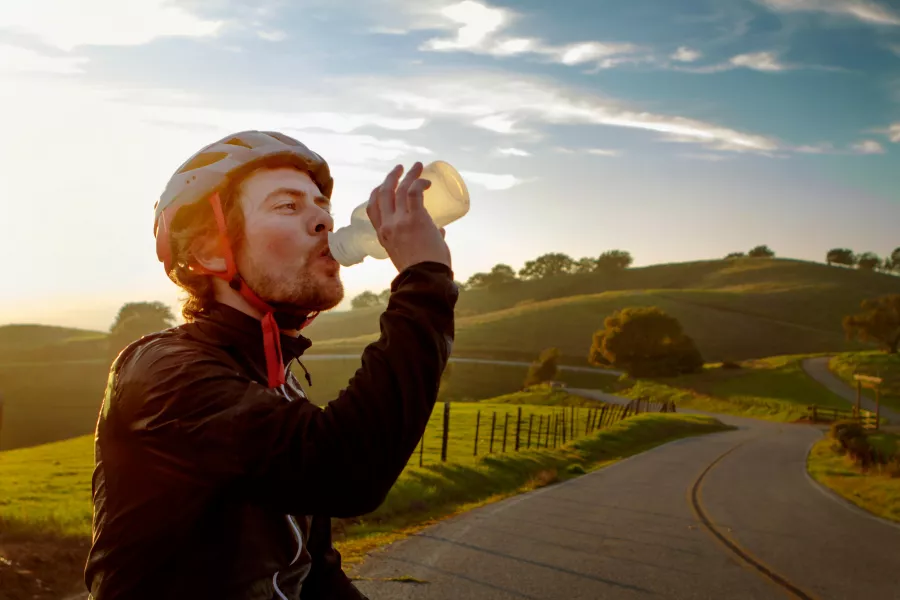 Cyclist having a drink