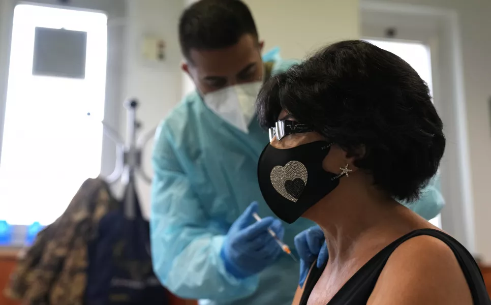 A medical worker administers a jab in Milan