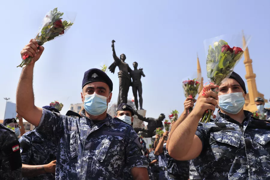 Police hold flowers in Beirut