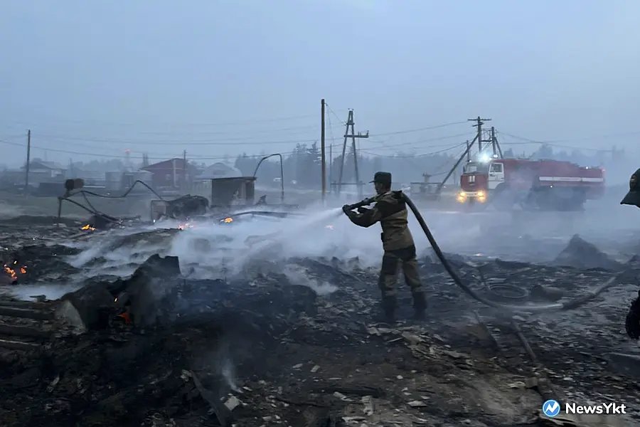 A firefighter douses a fire in Byas-Kuel village 