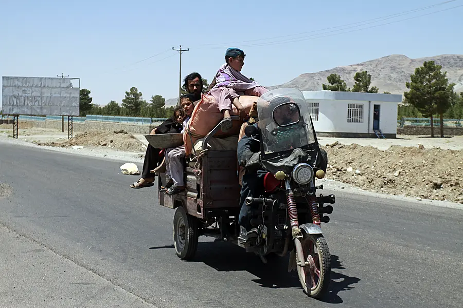 An Afghan family flees fighting as Afghan security personnel took back control of parts of the city of Herat following fighting between Taliban and Afghan security forces, on the outskirts of Herat, 640 kilometers (397 miles) west of Kabul, Afghanistan