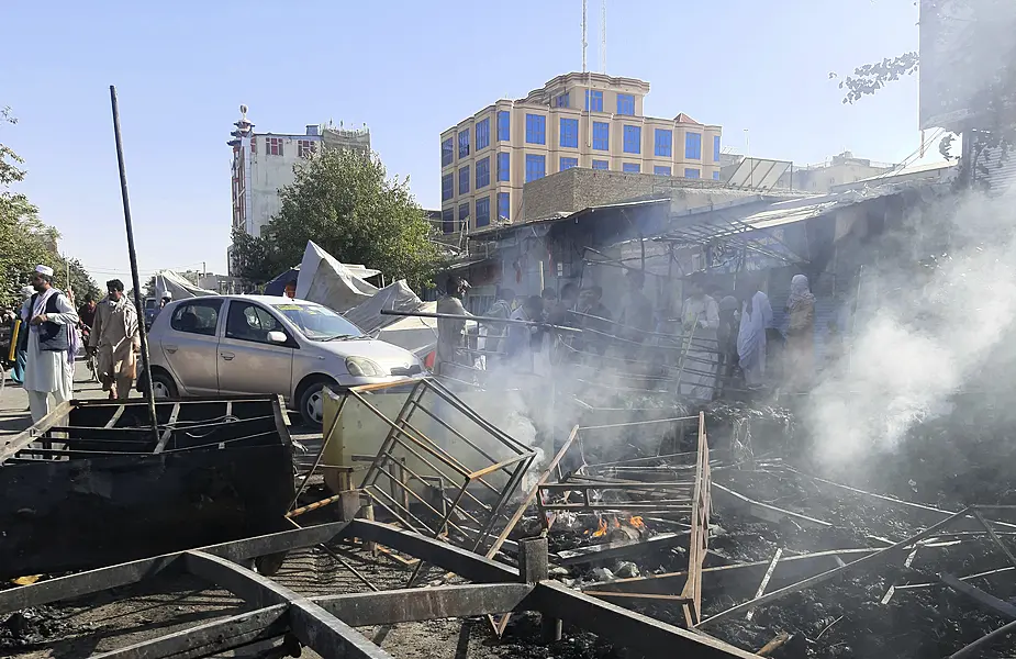 Smoke rises from damaged shops after fighting between Taliban and Afghan security forces in Kunduz city, northern Afghanistan 