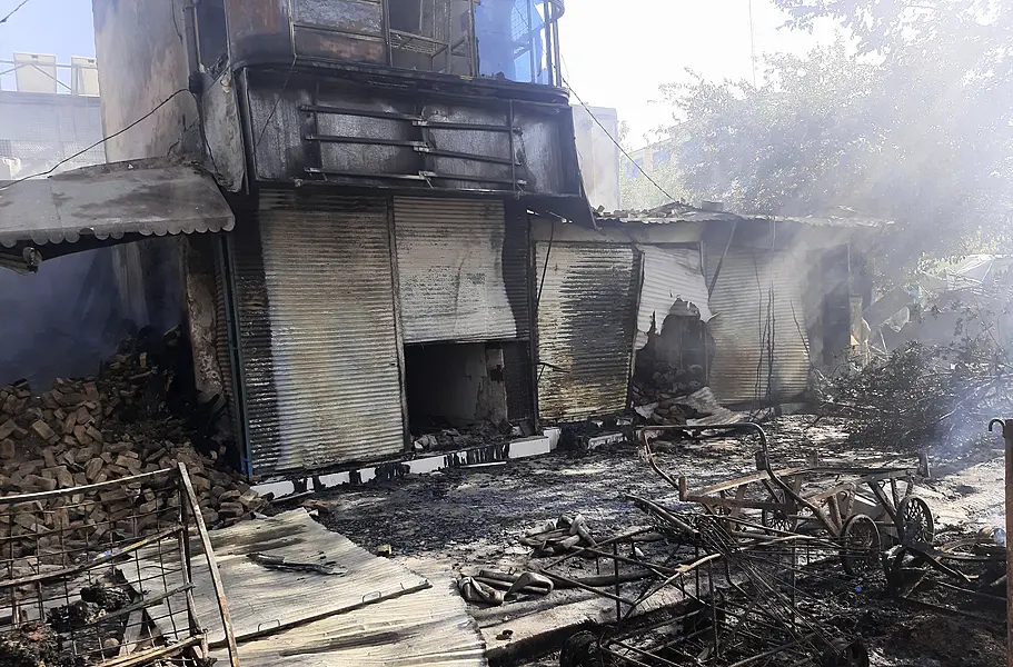 Smoke rises from damaged shops after fighting between Taliban and Afghan security forces in Kunduz city, northern Afghanistan