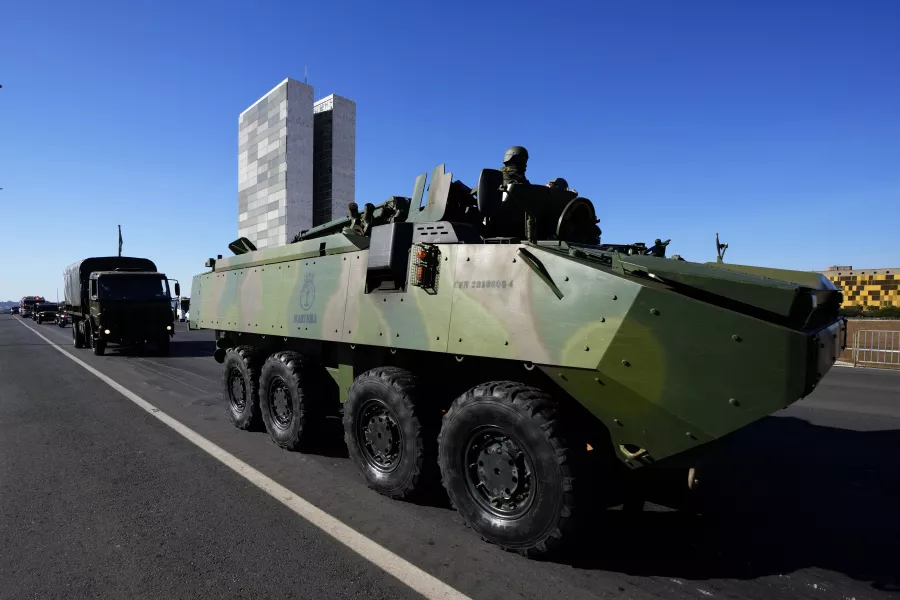 An armoured vehicle drives past congressional buildings