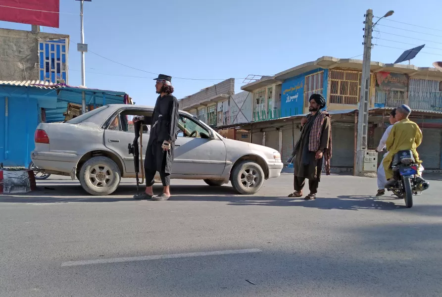 Taliban fighters at a checkpoint in the city of Farah