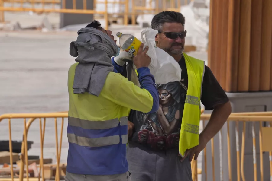Workers on a construction site stop to have a drink in Madrid, Spain 