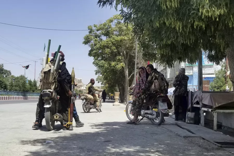 Taliban fighters patrol inside the city of Ghazni, south-west of Kabul