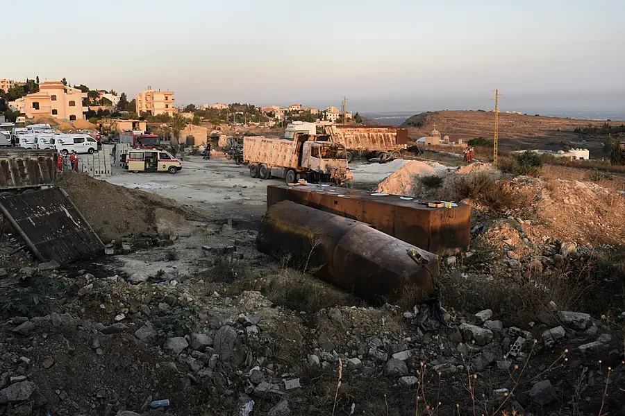 Rescue workers and Lebanese soldiers gather at the scene where a fuel tanker exploded in Tleil village, north Lebanon