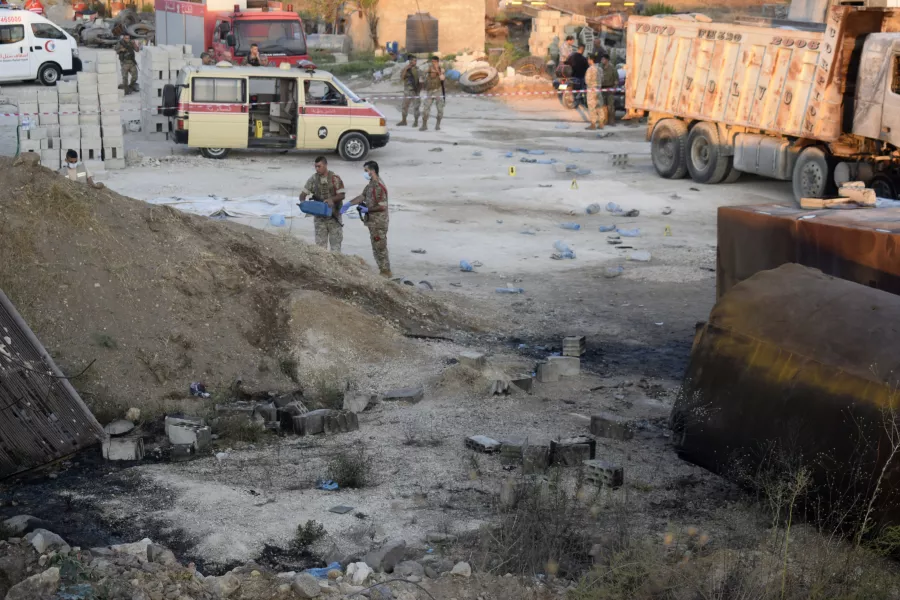 Lebanese soldiers investigate next to fuel tankers that exploded in Tleil village, north Lebanon 