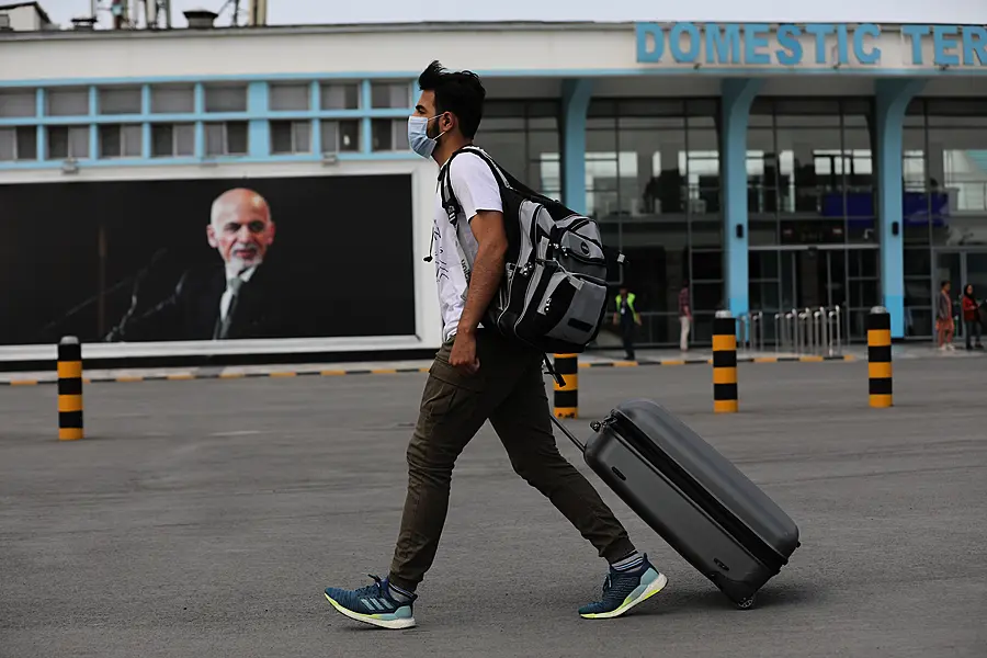 A passenger walks to the departures terminal of Hamid Karzai International Airport in Kabul, Afghanistan 