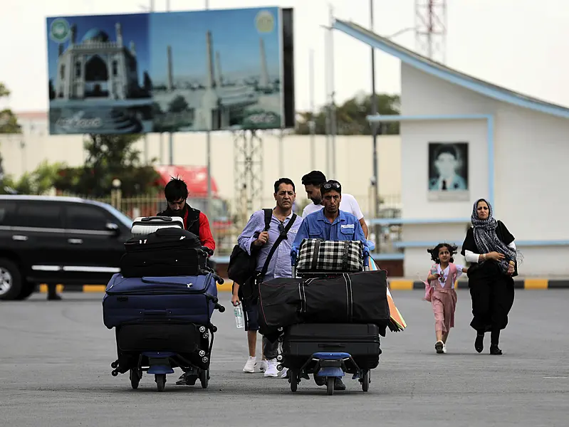 Passengers walk to the departures terminal of Hamid Karzai International Airport in Kabul