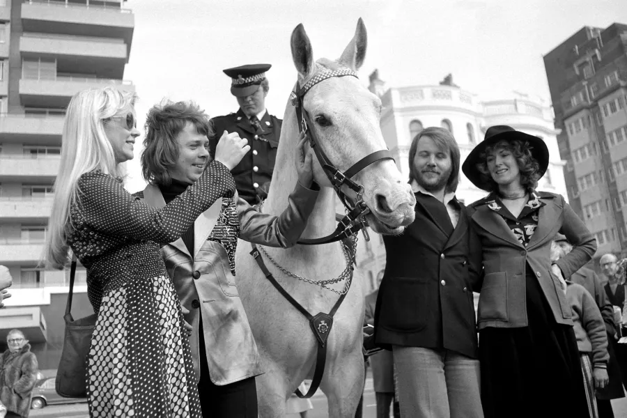 Swedish pop group Abba meet a mounted policeman as they relax in Brighton