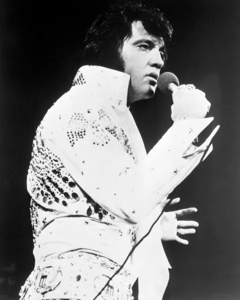 Elvis Presley wearing his iconic white jumpsuit