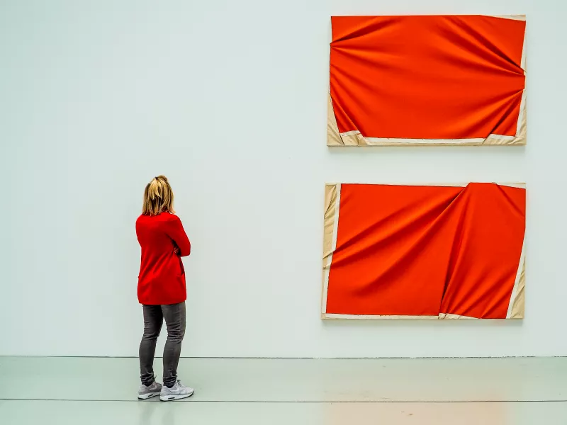 A woman views a brightly coloured work of art that matches her outfit in this image captured by Hans Lahodny from Austria