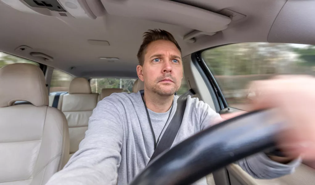Man looking worried while driving car