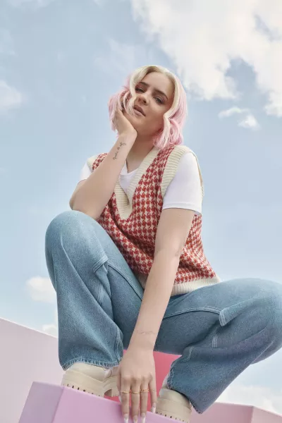 New Look Anne-Marie Loves Red Dogtooth V Neck Vest; White Basic Cotton T-Shirt; Blue Mid Wash High Waist Adalae Wide Leg Jeans