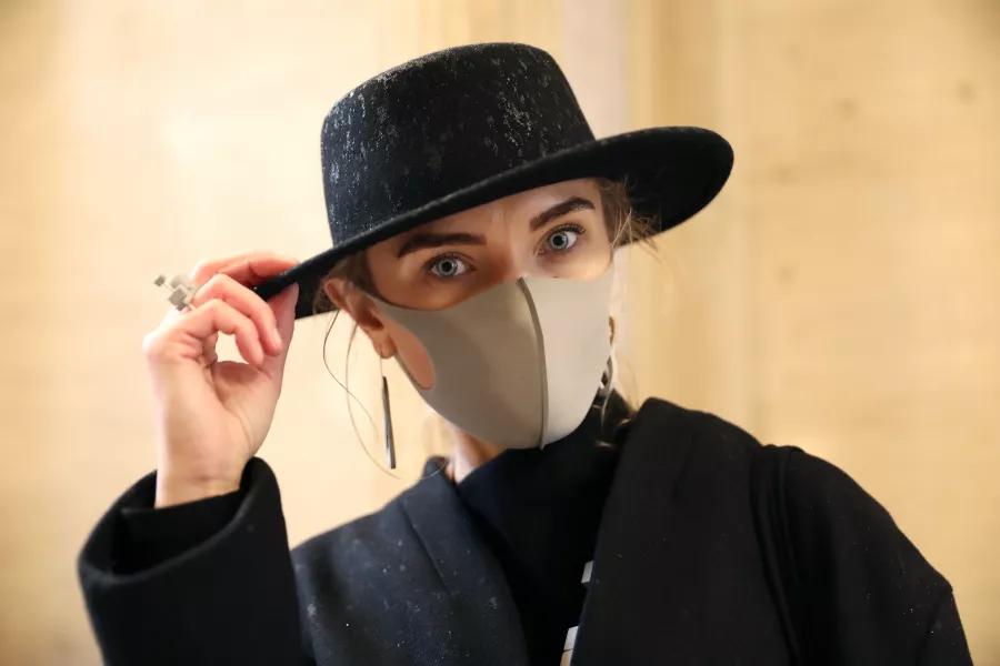 Woman wearing a face mask and hat