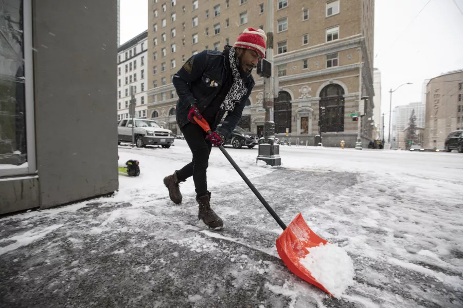 Someone shovels snow