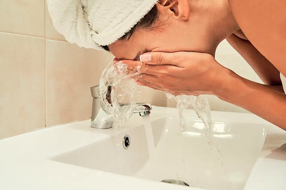 Woman washing her face