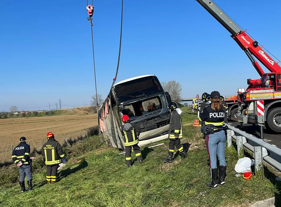 Police and rescue services attend the scene of the crash near Forli on Sunday 