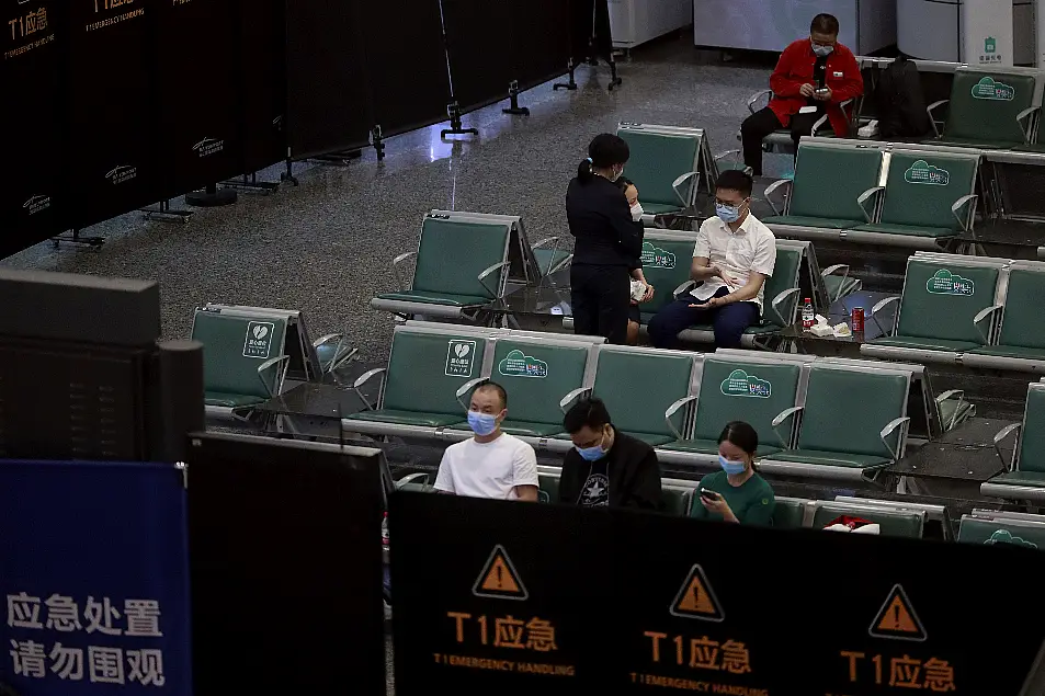 People sit in a temporarily cordoned off area for the relatives of the victims aboard China Eastern's flight MU5735, in Guangzhou Baiyun International Airport in Guangzhou, capital of south China's Guangdong Province