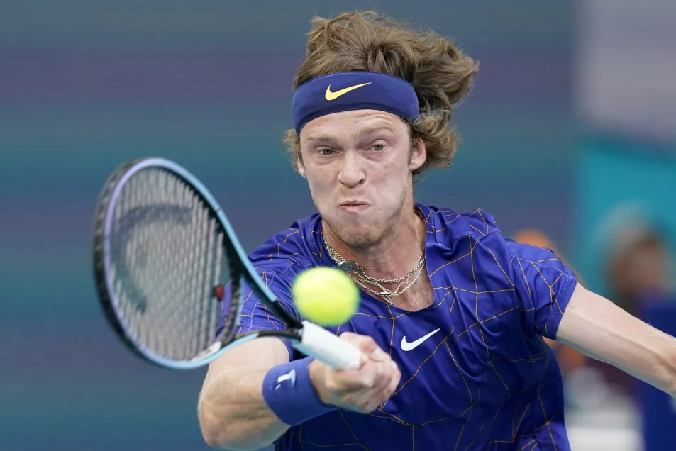 Andrey Rublev, of Russia, returns a shot from Nick Kyrgios, of Australia, during the Miami Open tennis tournament on Friday