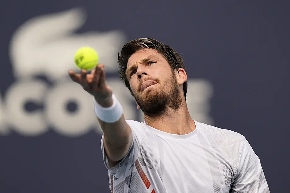 Cameron Norrie serves to Jack Draper, both of Great Britain, during the Miami Open tennis tournament, Friday, March 25, 2022, in Miami Gardens, Fla