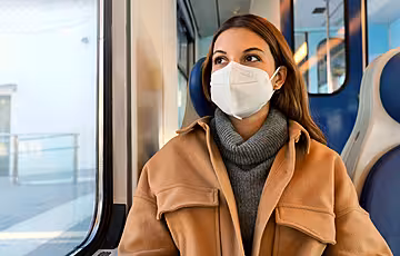 Woman wearing face mask on bus