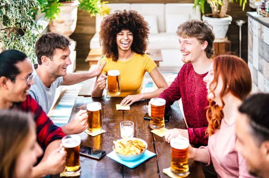 Friends drinking beer around a table