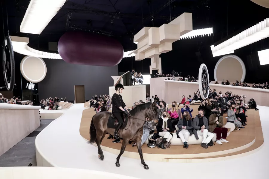 Charlotte Casiraghi rides a horse as she wears a creation for the Chanel Spring-Summer 2022 Haute Couture fashion collection 