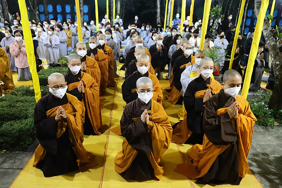 Monks and Thich Nhat Hanh followers pray during the funeral of the Vietnamese Buddhist monk in Hue, Vietnam Saturday, Jan. 29, 2022. A funeral was held Saturday for Thich Nhat Hanh, a week after the renowned Zen master died at the age of 95 in Hue in central Vietnam. (AP Photo/Thanh Vo)