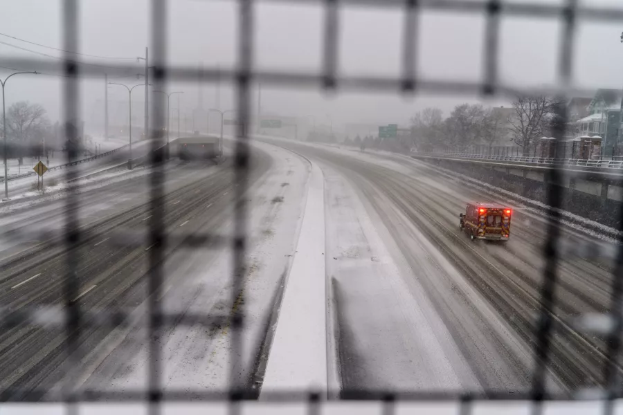 A lone vehicle on a snowy road